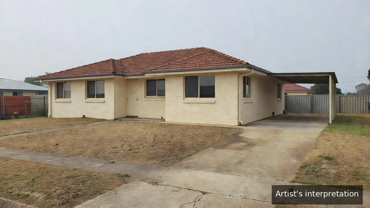 A semi-modern single-storey Ipswich house in painted brick with a tiled roof, a concrete driveway running hard against the side wall and a dry lawn, on an ordinary Queensland suburban street.